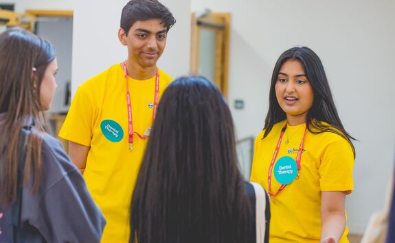 two students talking at an open day to visitors